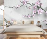 3D floral wallpaper mural featuring soft pink cherry blossom flowers and tree branches on a light grey background in a modern kids room setting.