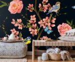 Dark floral wallpaper mural with pink roses, blossom branches, blue bird and butterflies on deep navy background.