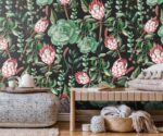 "Wall mural of tropical Protea flower with dense green botanical leaves - natural plant background for home decor"