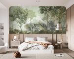 Green foggy forest wall mural with tropical leaves behind a sage sofa and armchair