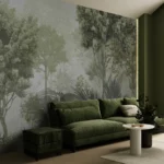 Green foggy forest wall mural with tropical leaves behind a sage sofa and armchair