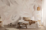 Soft beige leaf pattern wall mural behind a bed in a neutral-toned bedroom