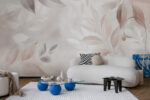 Soft beige leaf pattern wall mural behind a bed in a neutral-toned bedroom